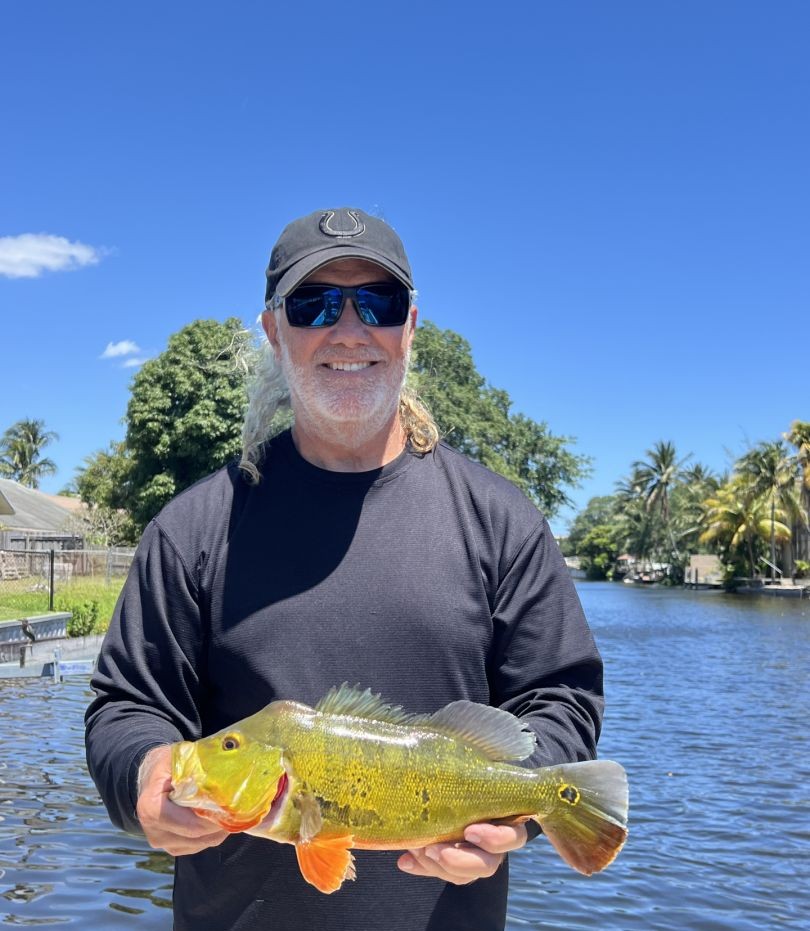 Peacock bass catch displayed near waterway in Fort Lauderdale FL