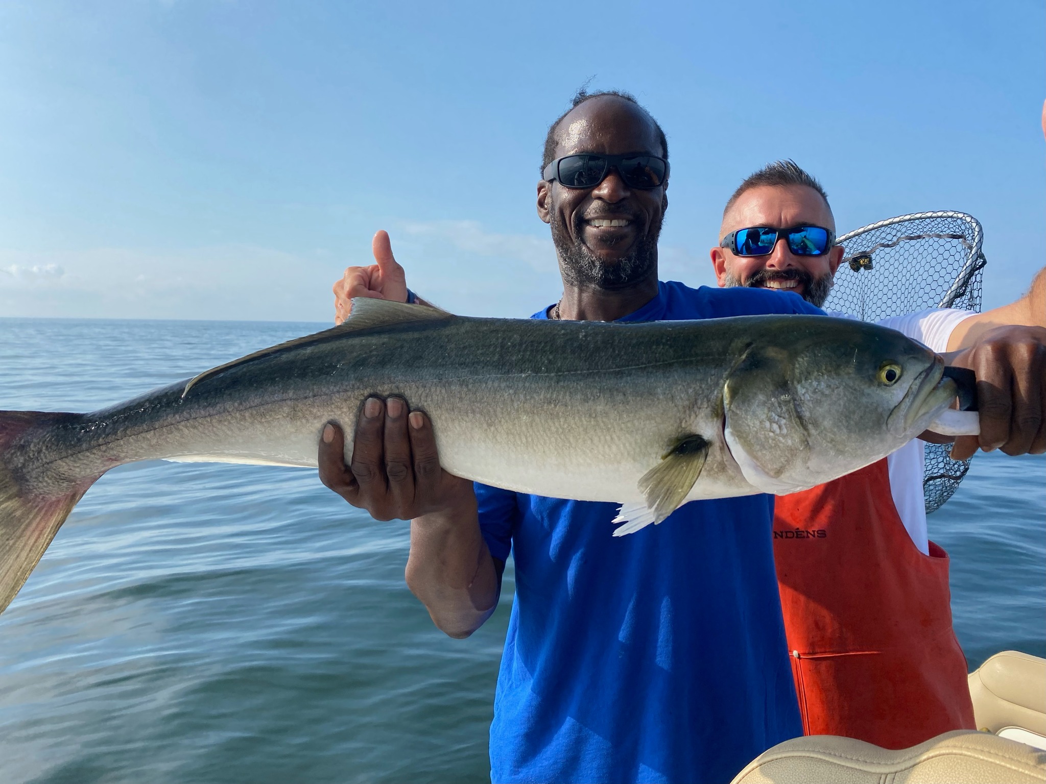 A pair of anglers catching a large 39-inch fish in Connecticut