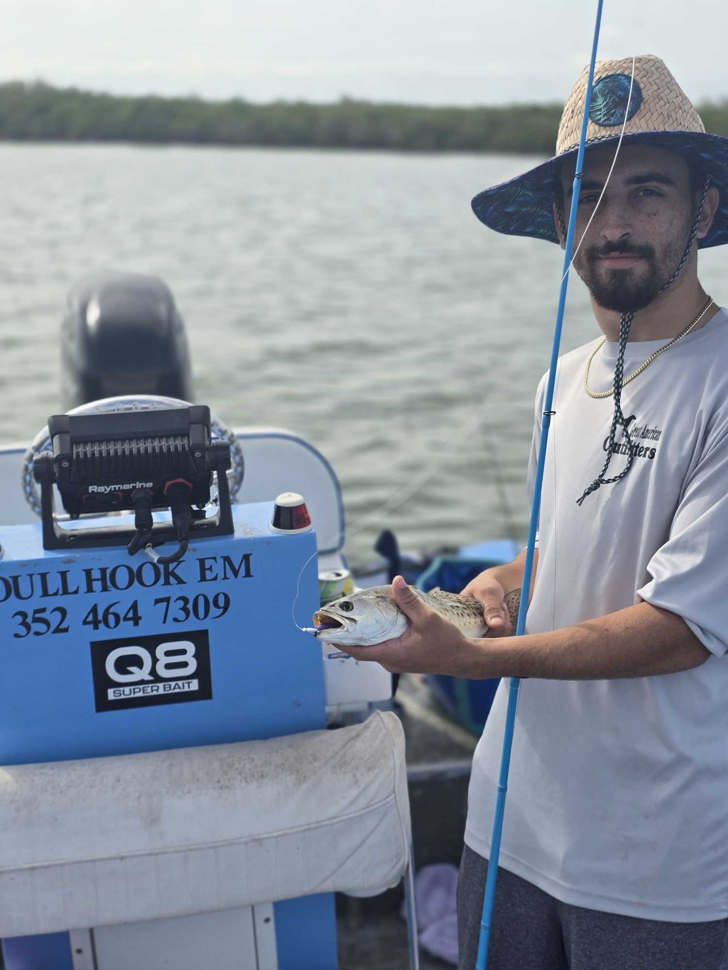 Fishing guide holding caught fish on charter boat in Homosassa FL waters