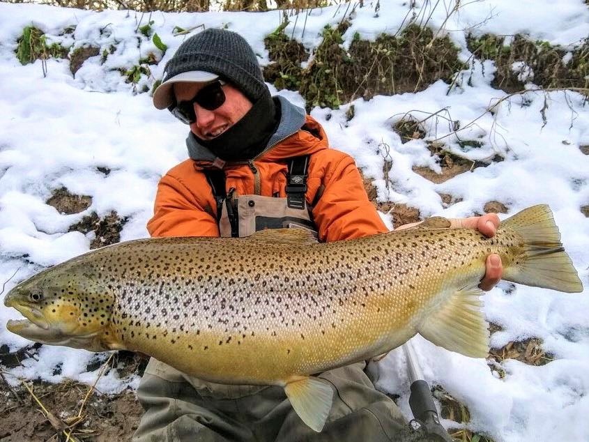 Angler with a large rainbow trout caught in Sheboygan