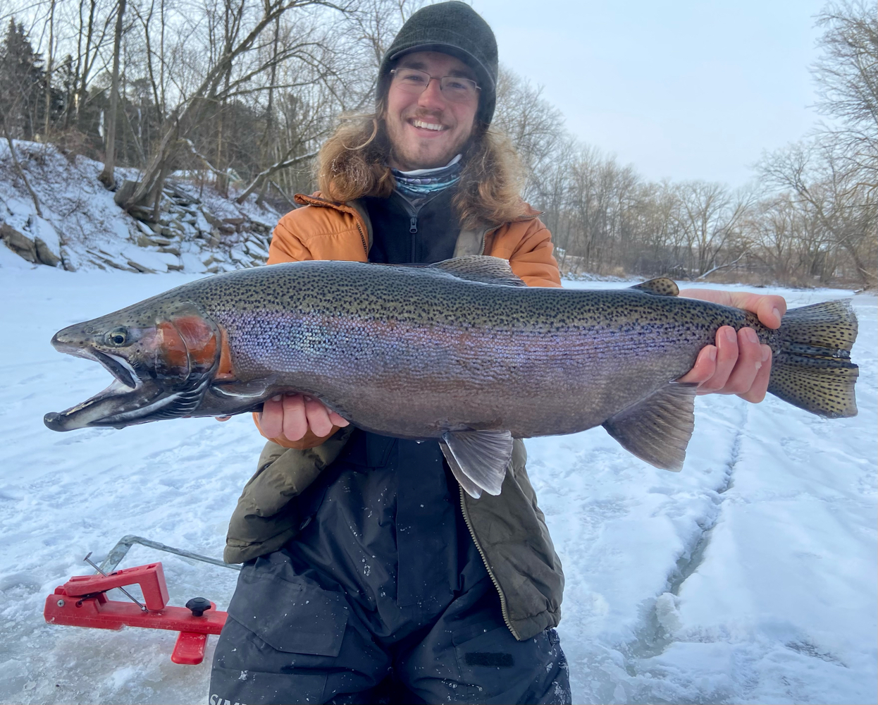 Angler holding a large rainbow trout in Wisconsin