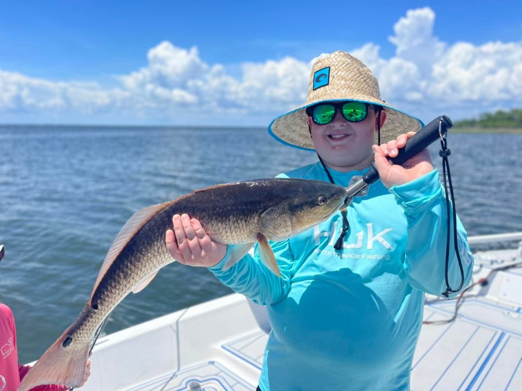 A lone angler reeling in a catch at Santa Rosa Beach
