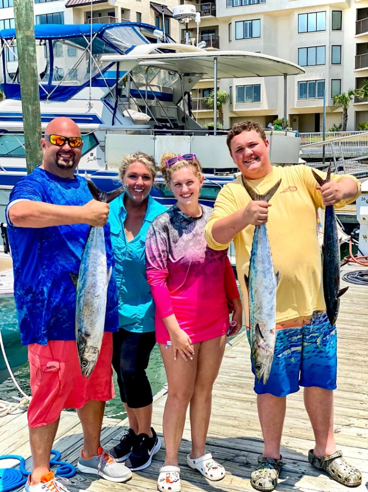 Three anglers fishing in South Carolina with their catch