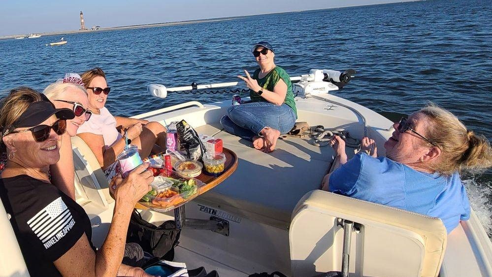 Three people enjoying a fishing tour in Folly Beach