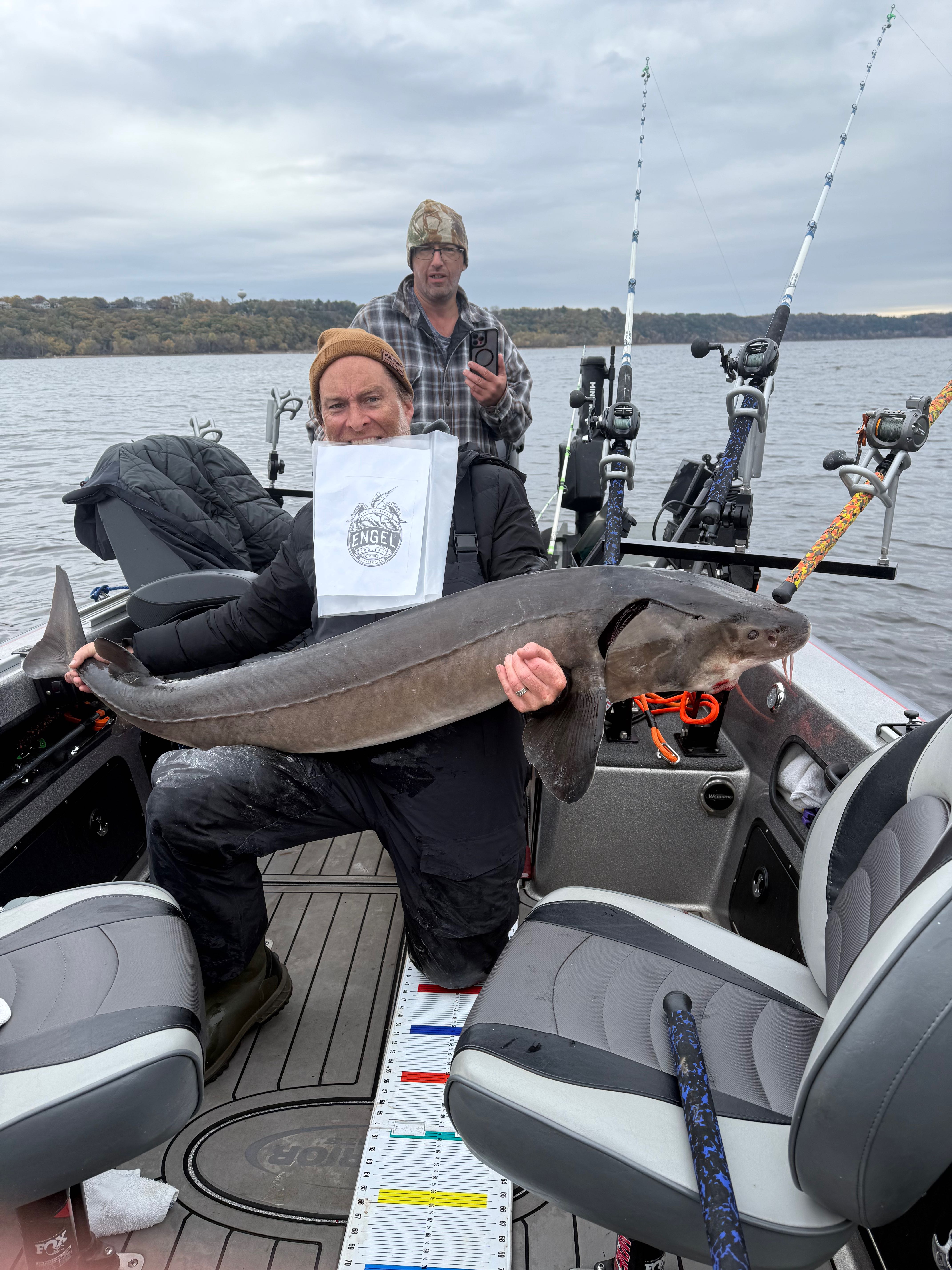 Lake sturgeon catch on fishing boat in Stillwater MN with measuring board and fishing equipment