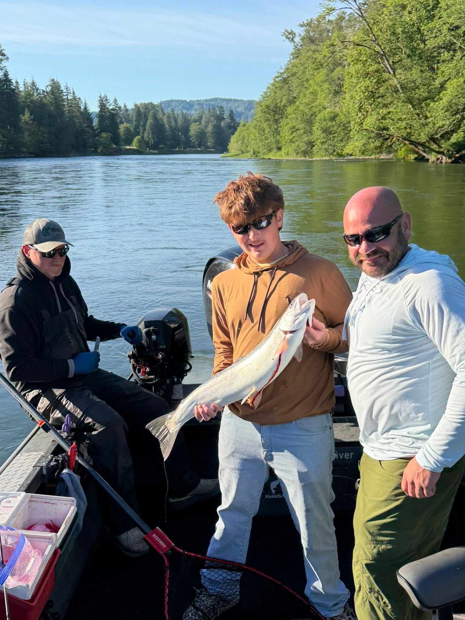 Fishing trip on river in Montesano WA with caught fish displayed on boat