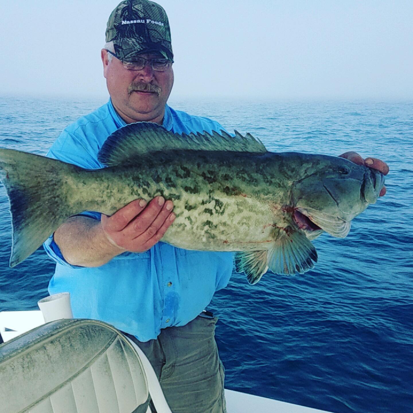 Angler posing with large fish catch in Pensacola
