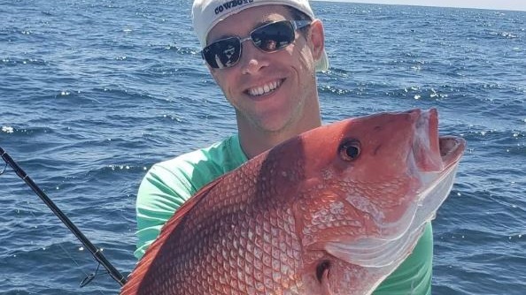 Angler with a 14-inch fish in Gulf Shores