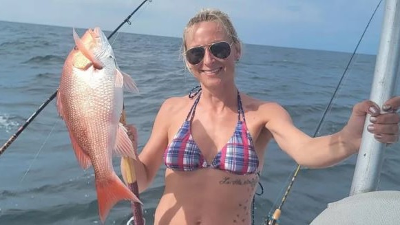 A lone angler fishing in the waters of Gulf Shores