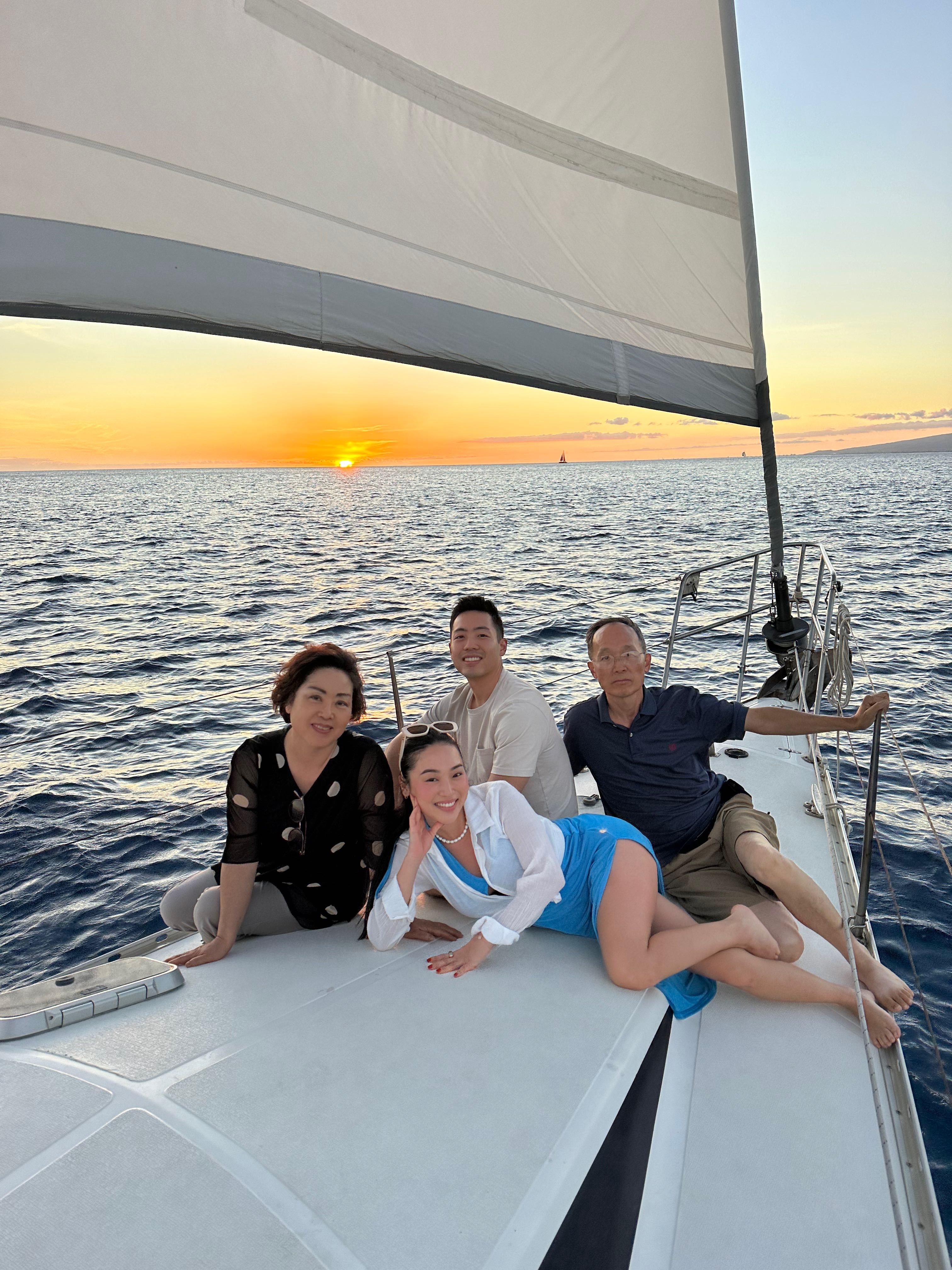 Family enjoying sunset cruise on sailboat in Honolulu Hawaii waters