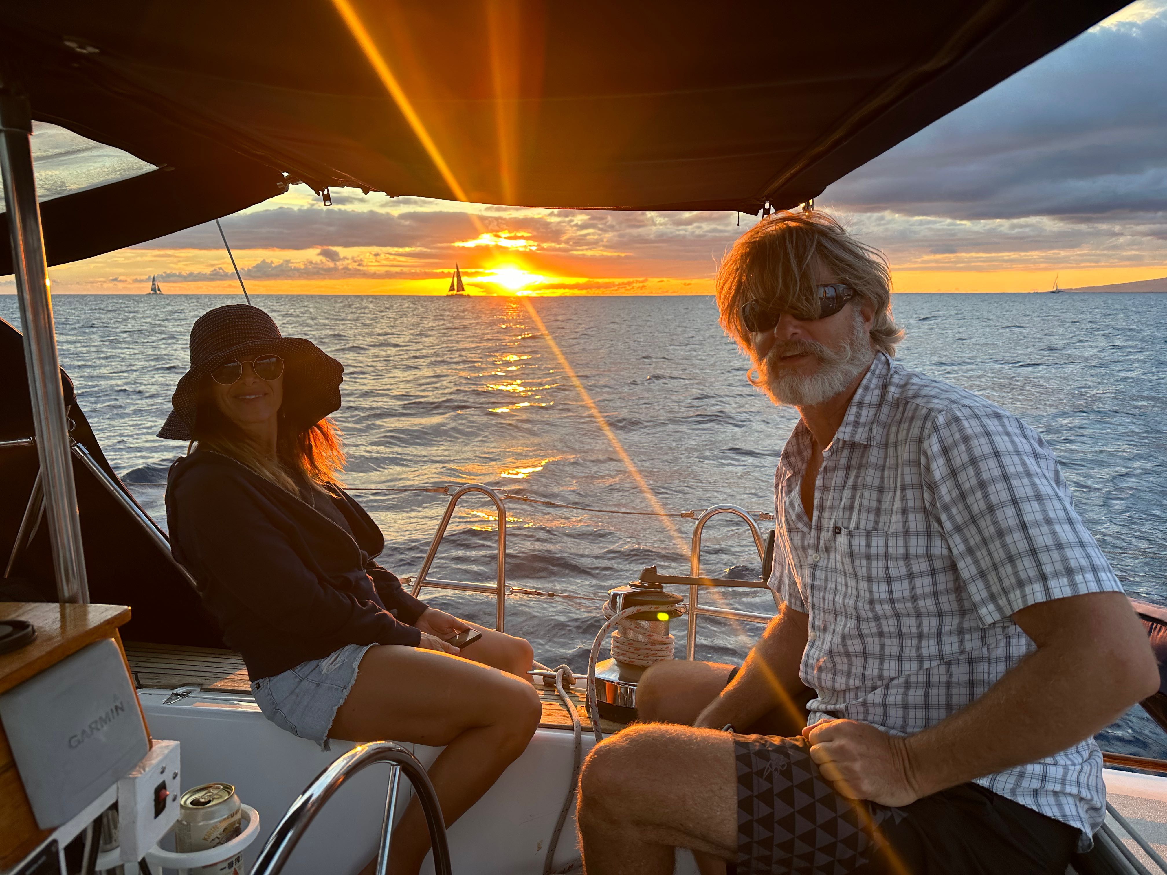 Sunset cruise sailing in Honolulu waters with distant sailboats on the horizon