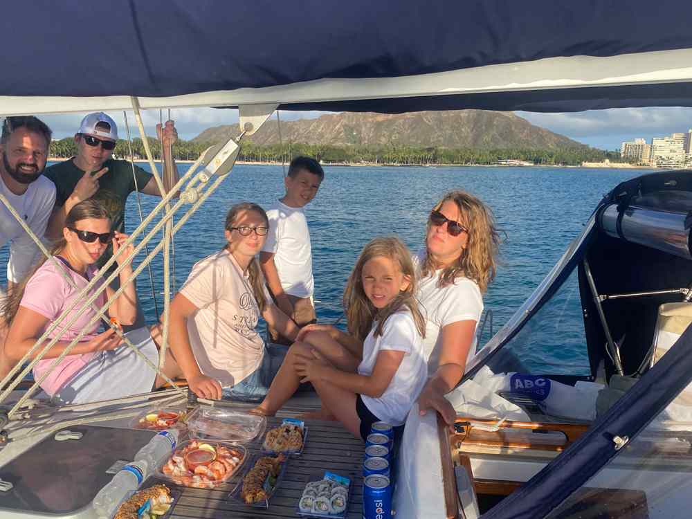 Private sailing charter boat cruising past Diamond Head crater in Honolulu Hawaii waters