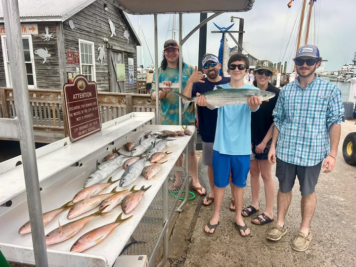 Fresh caught fish displayed on cleaning table at Key West fishing dock with successful fishing group