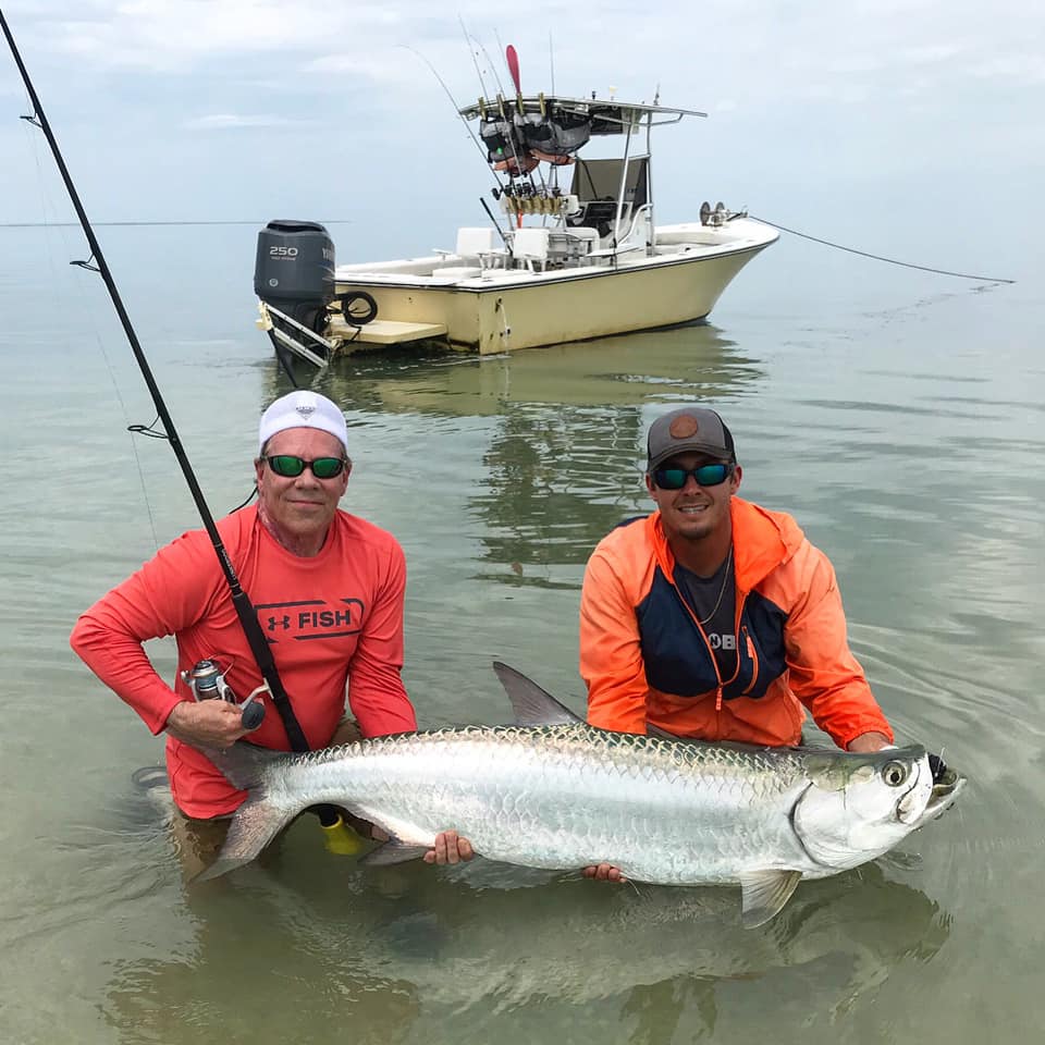 Two people fishing for a tarpon in FL