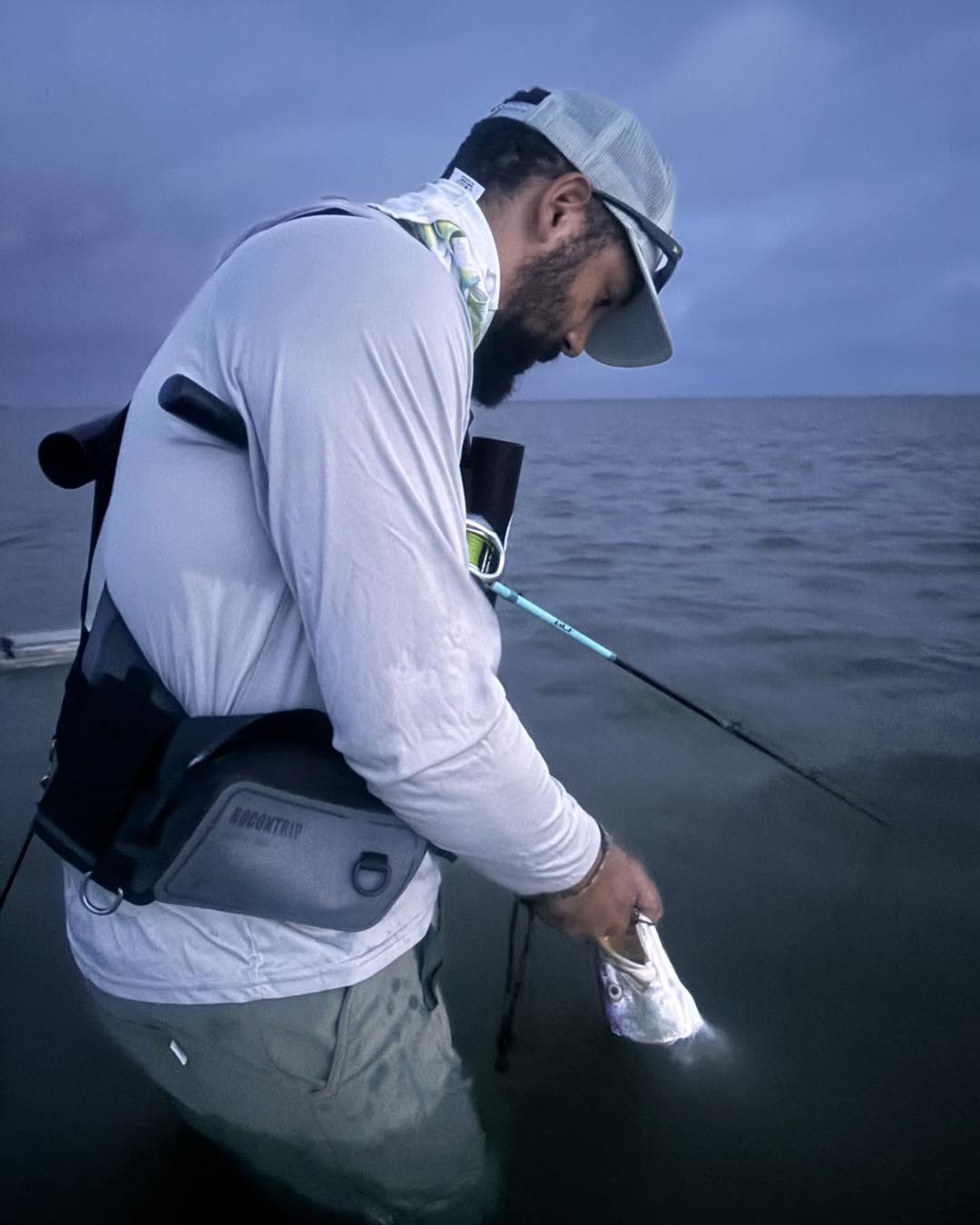 Angler holding caught fish on boat in Aransas Pass TX waters