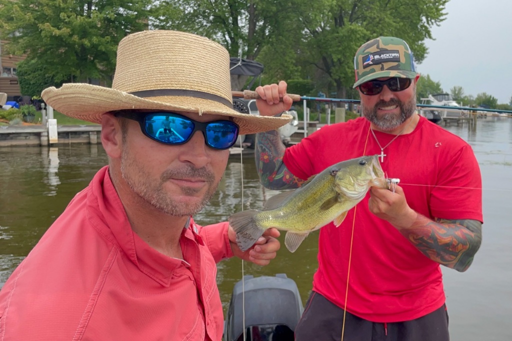 Two anglers holding a freshly caught fish in Wisconsin