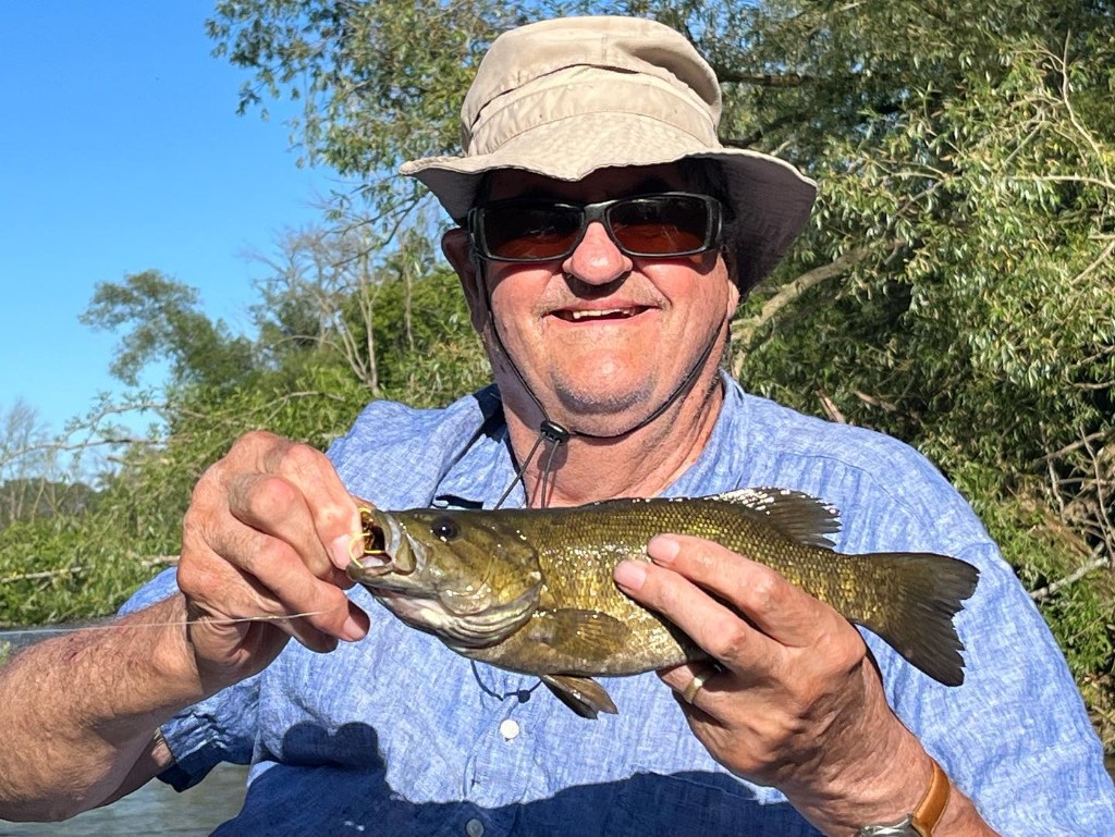 Angler holds a fish in Omro