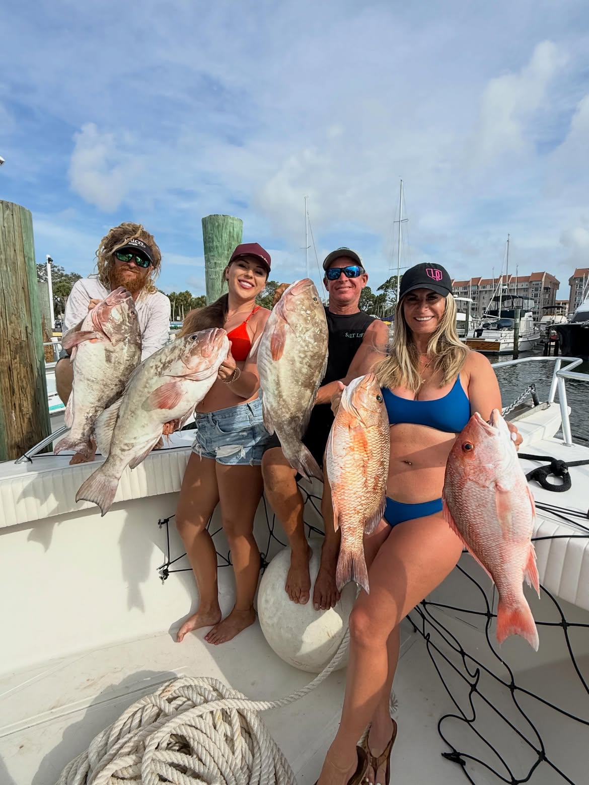 Successful fishing trip in Clearwater FL with red snapper, red grouper, and grey snapper catch displayed on boat deck