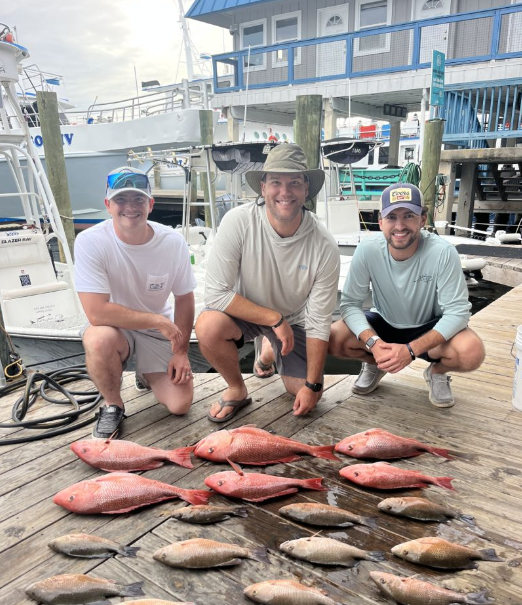 Red snapper fishing catch displayed on dock in Panama City FL with multiple fish species