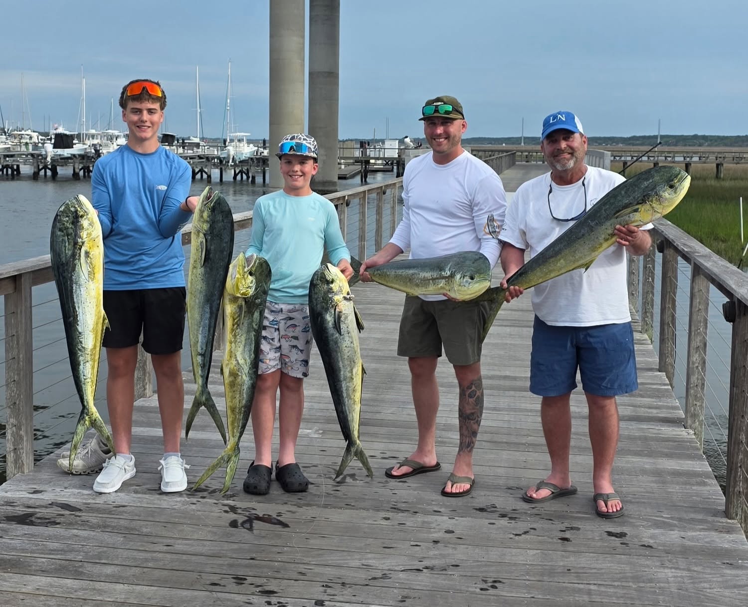 Successful mahi mahi fishing trip in Charleston SC with multiple fish displayed on dock