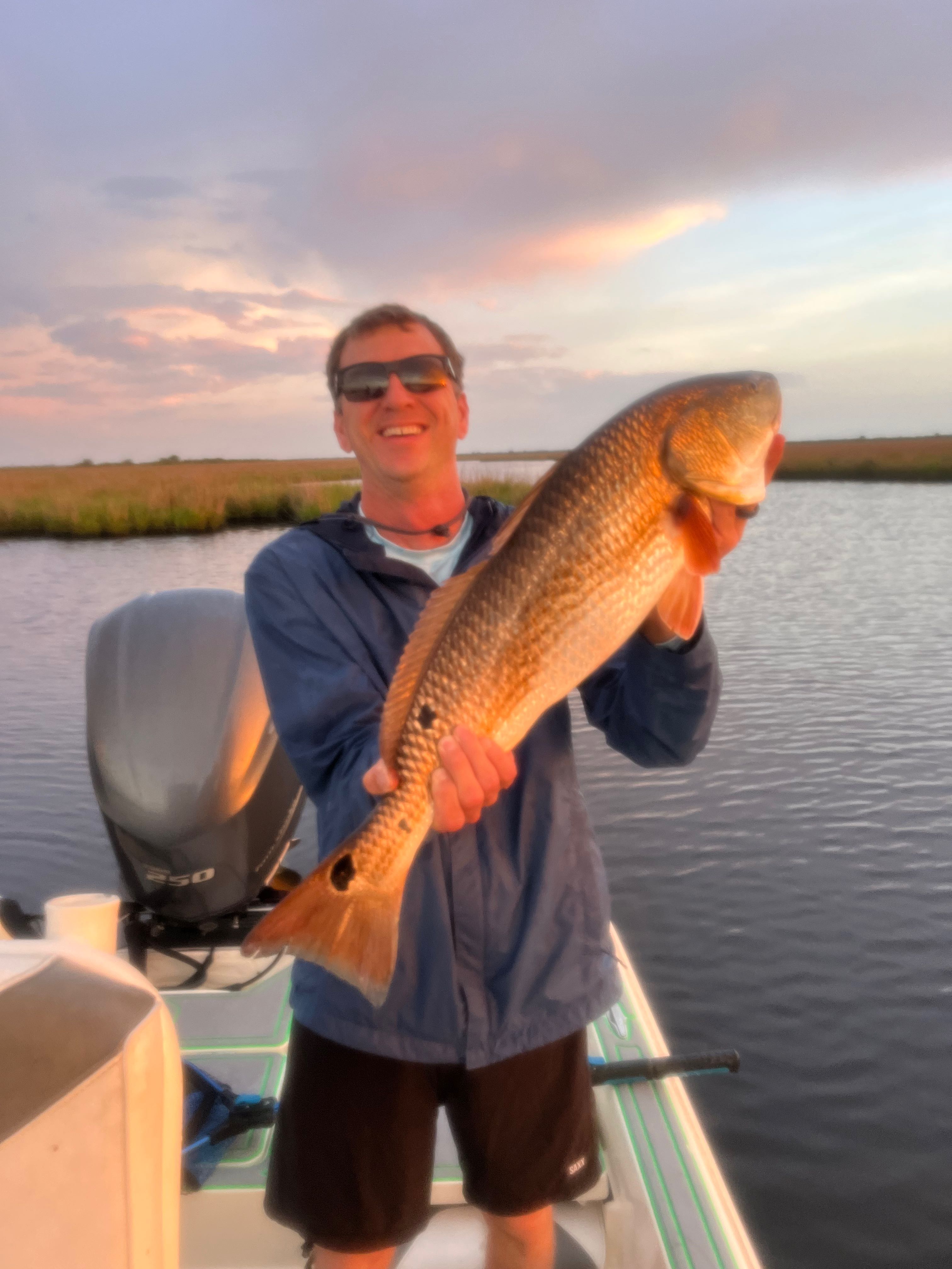 Large redfish caught during fishing trip in St Bernard Louisiana at sunset