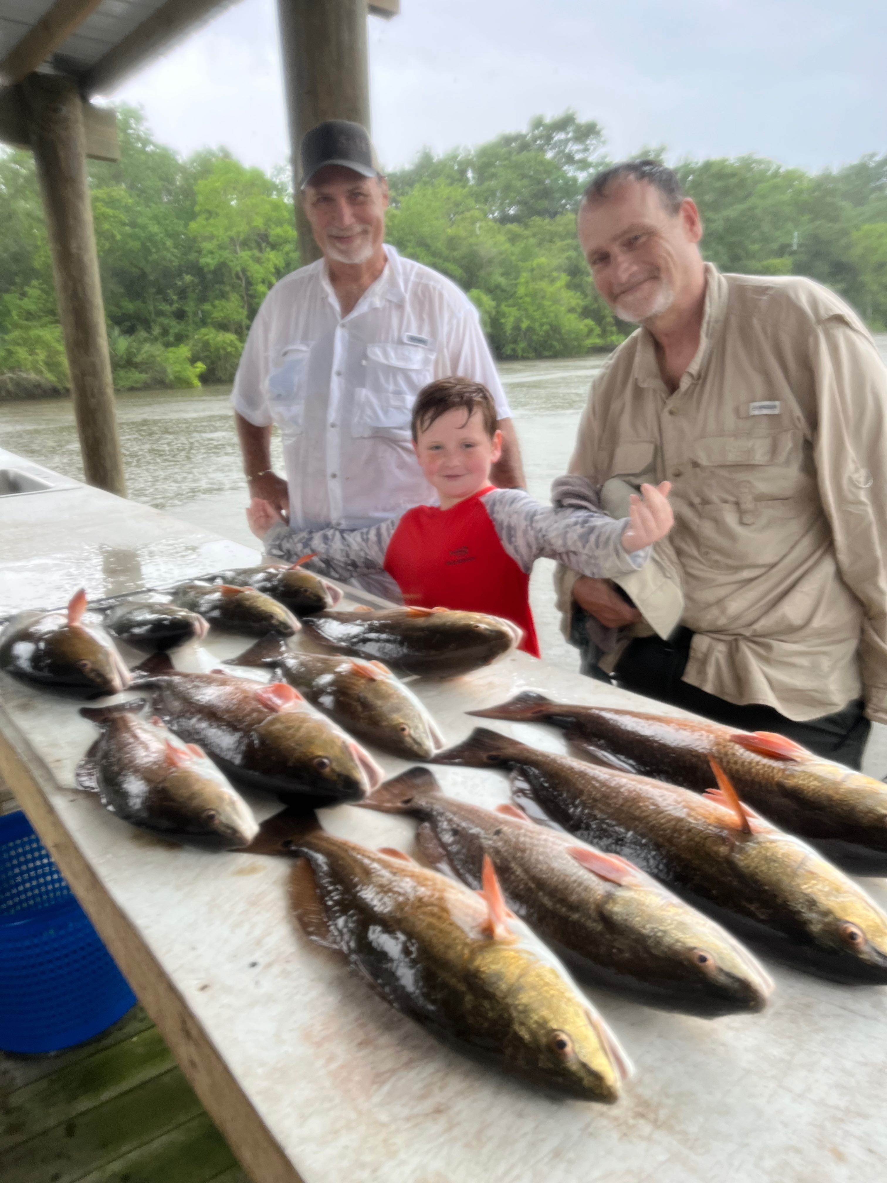 Successful fishing trip displaying multiple redfish catch on cleaning table in St Bernard LA