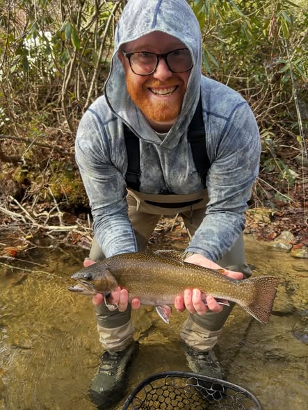 Fly fishing guide and angler on North Carolina mountain river near Flat Rock trout waters