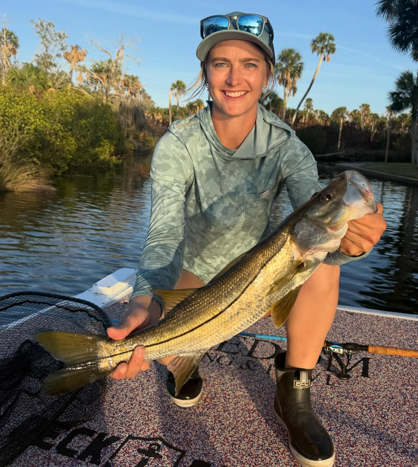 Angler holding caught snook fish on boat in Spring Hill FL waters