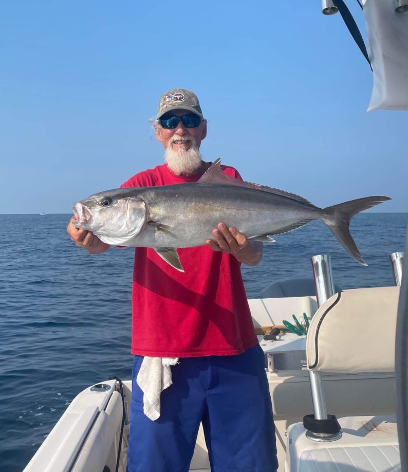 Fisherman with a greater amberjack fish in FL