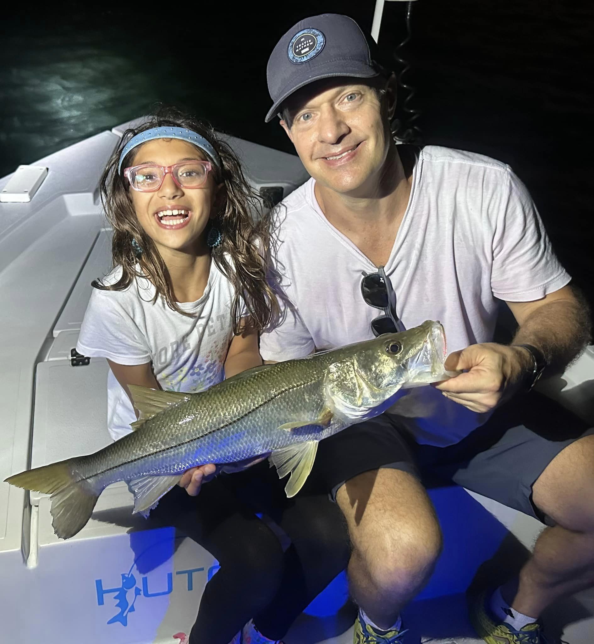 A snook fish being caught by two people in Key Biscayne