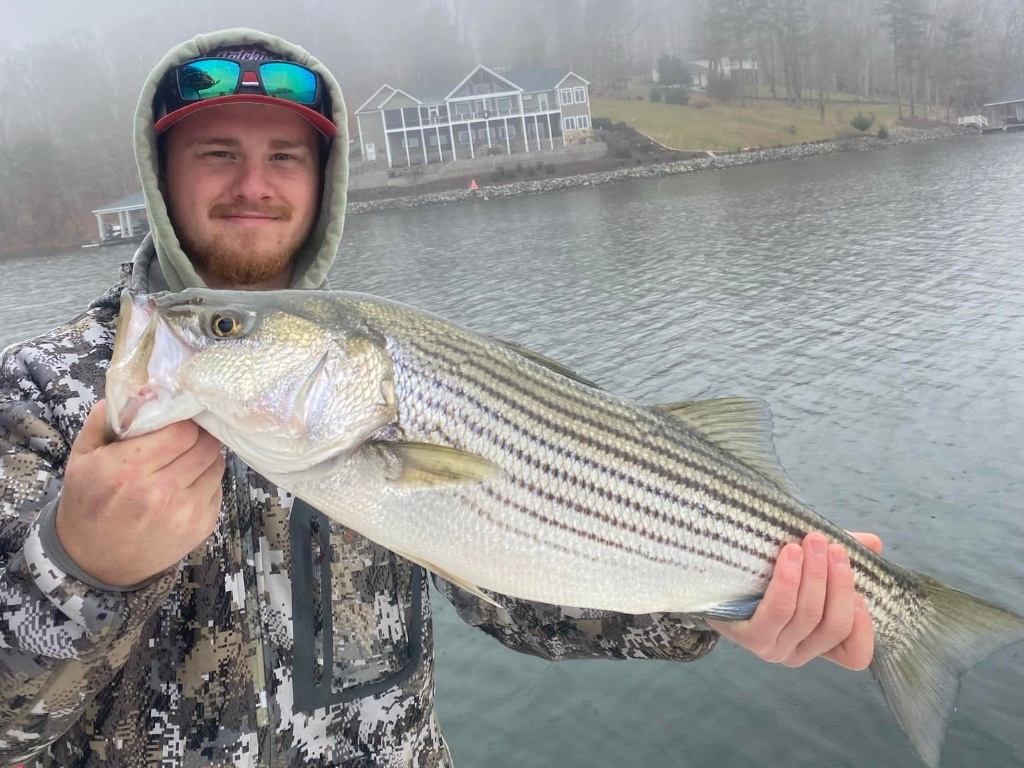 Angler with striped bass fish catch in Moneta