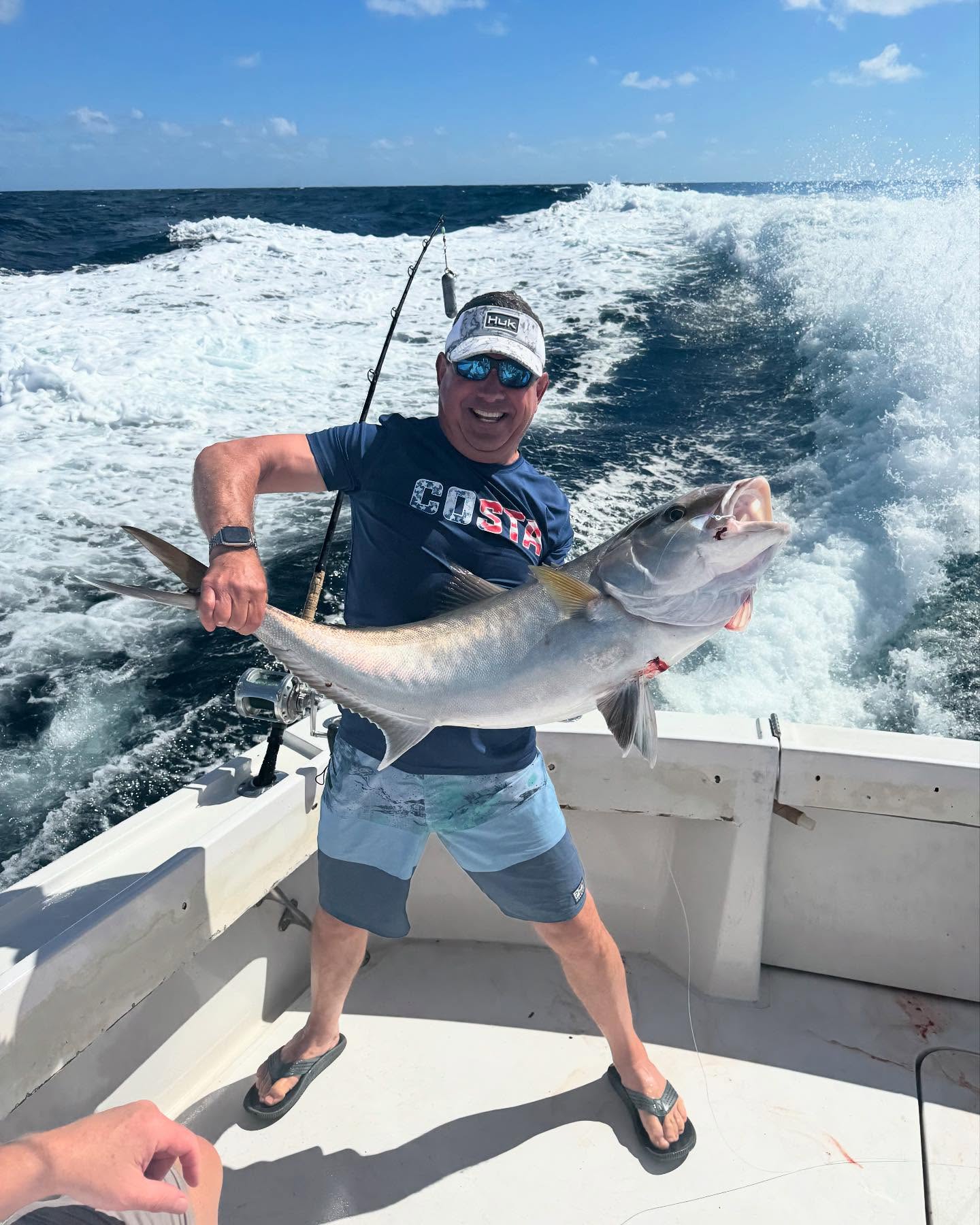 Person fishing with rod at Pompano Beach