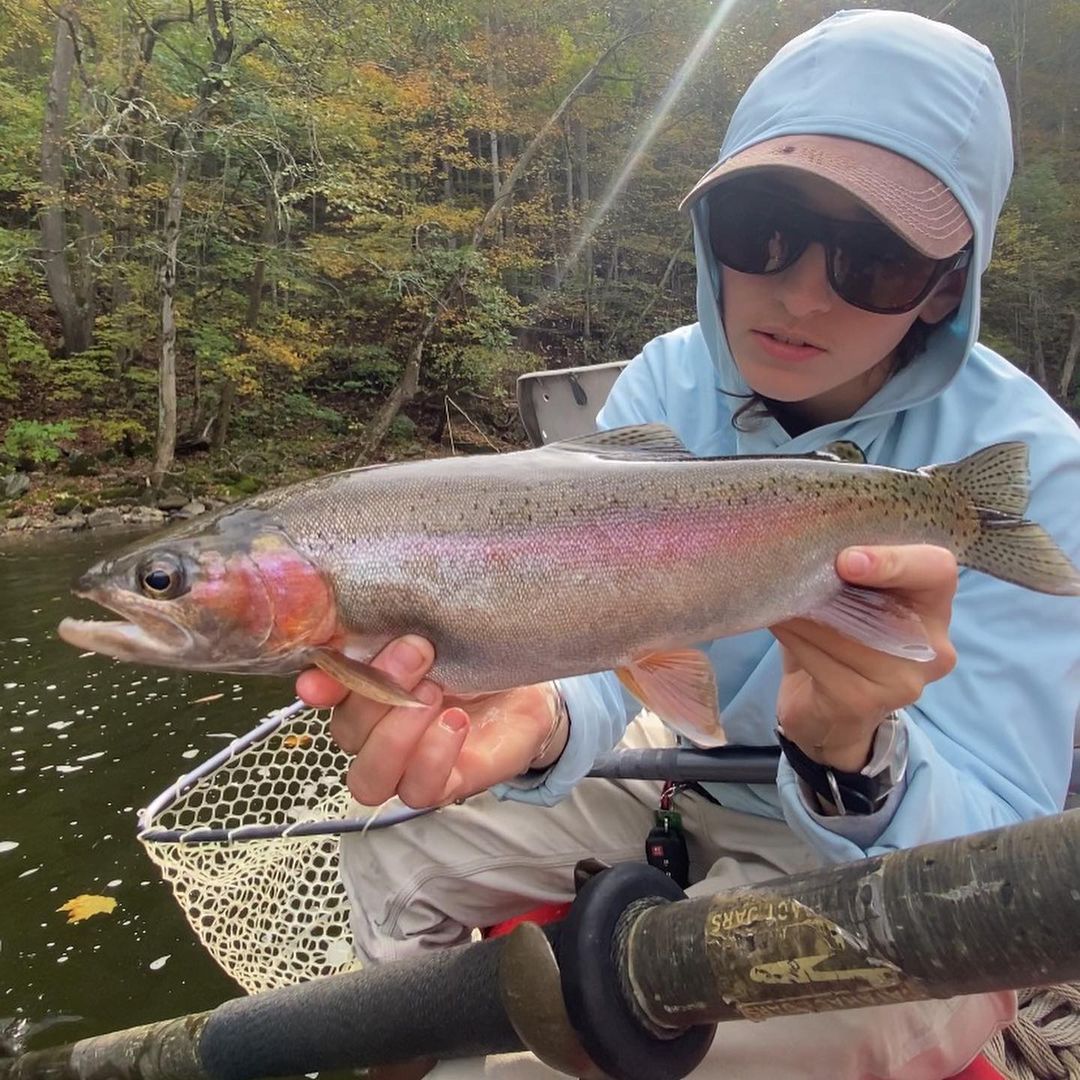 A fisherman holding a large rainbow trout in Florida