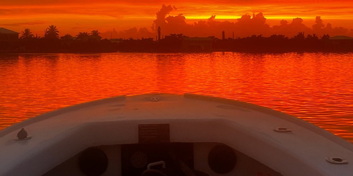 Big Pine Key sunset dolphin tour on 28ft Intrepid boat with golden sky and calm ocean waters