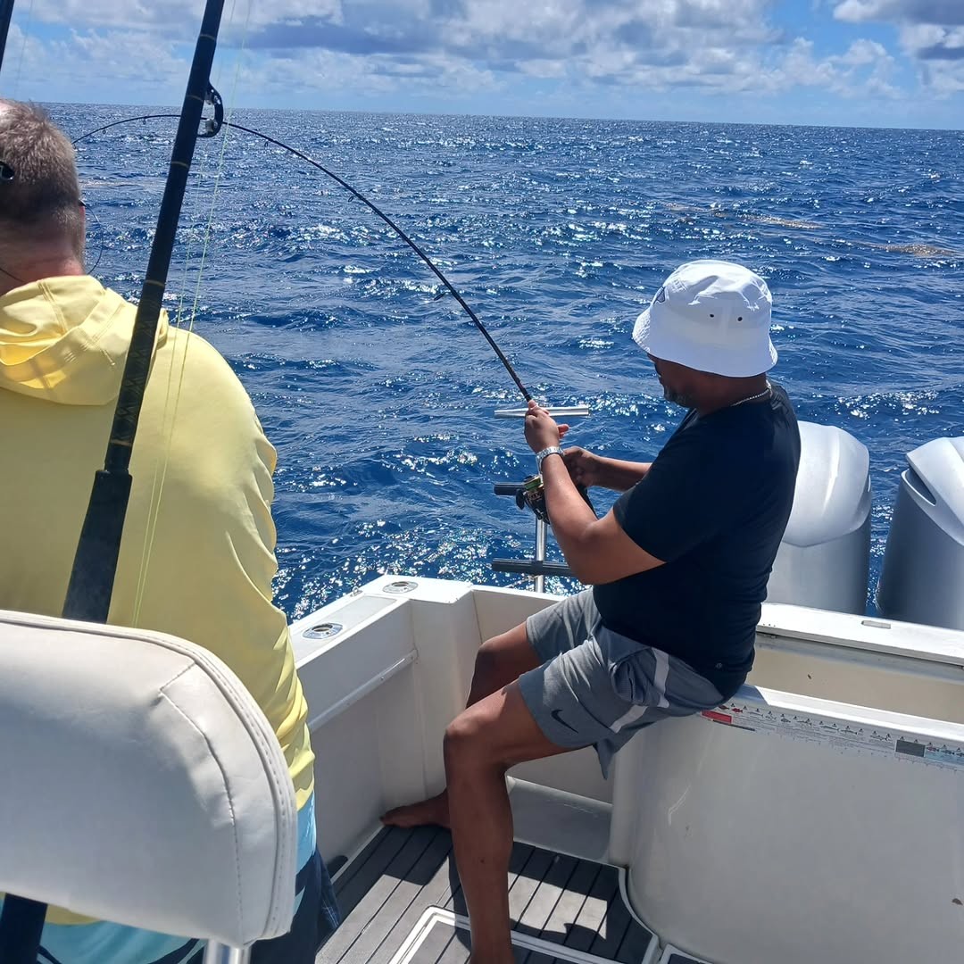 Deep sea fishing with bent rod indicating fish on the line in Punta Cana waters