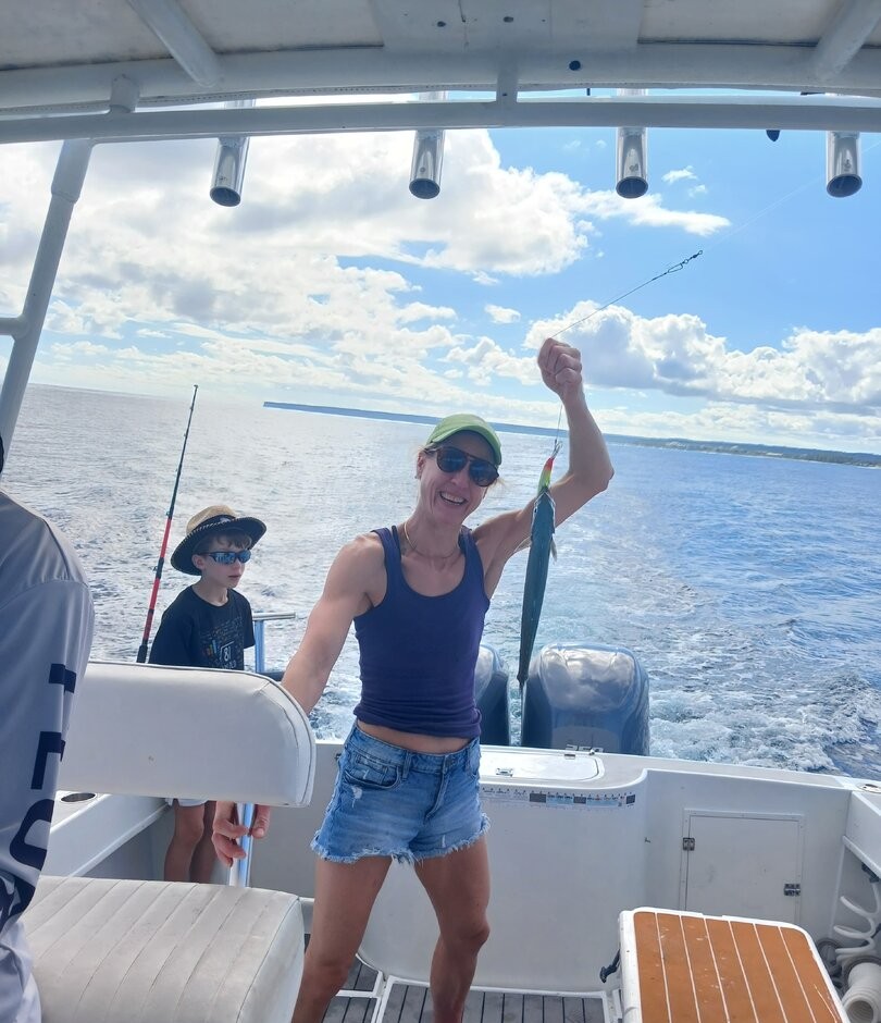 Fishing boat on open ocean water near Punta Cana with fishing equipment visible