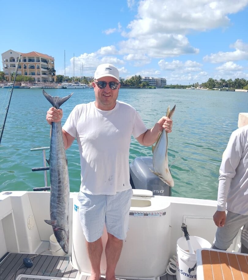 Successful fishing trip in Punta Cana showing fresh caught wahoo and second fish species on boat