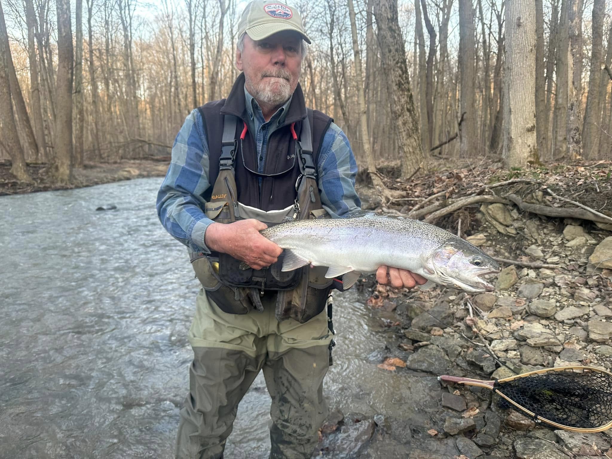 Angler catches a beautiful rainbow trout in the waters of Geneva