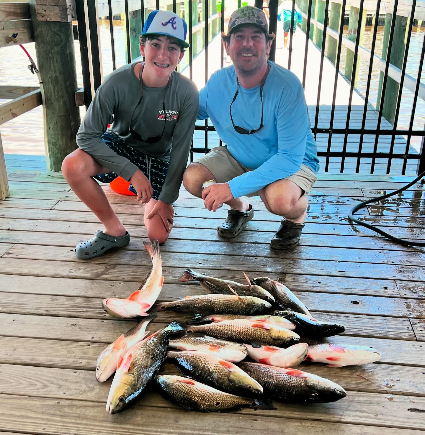 Successful redfish fishing trip in Lake Charles LA with multiple red drum caught on wooden dock