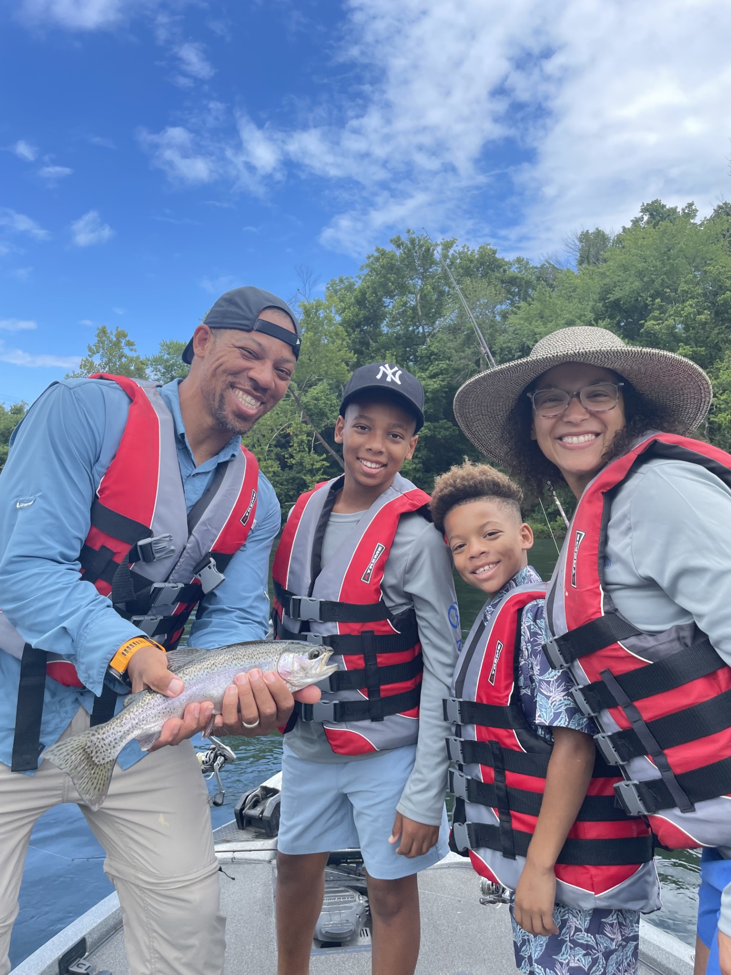 4 people fishing in Branson with a 14-inch catch