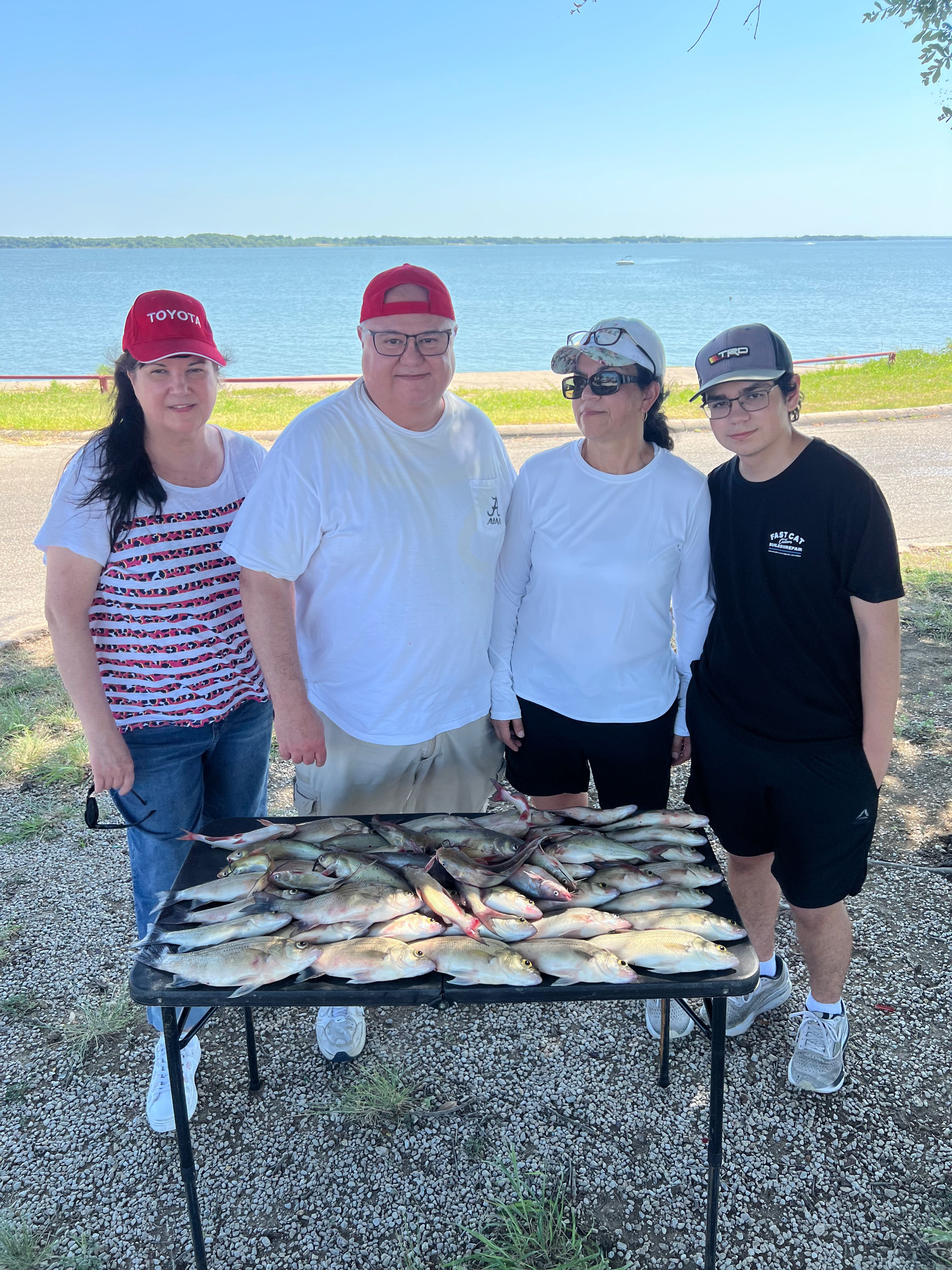 Large catch of fish displayed on table after successful fishing trip in Wylie TX