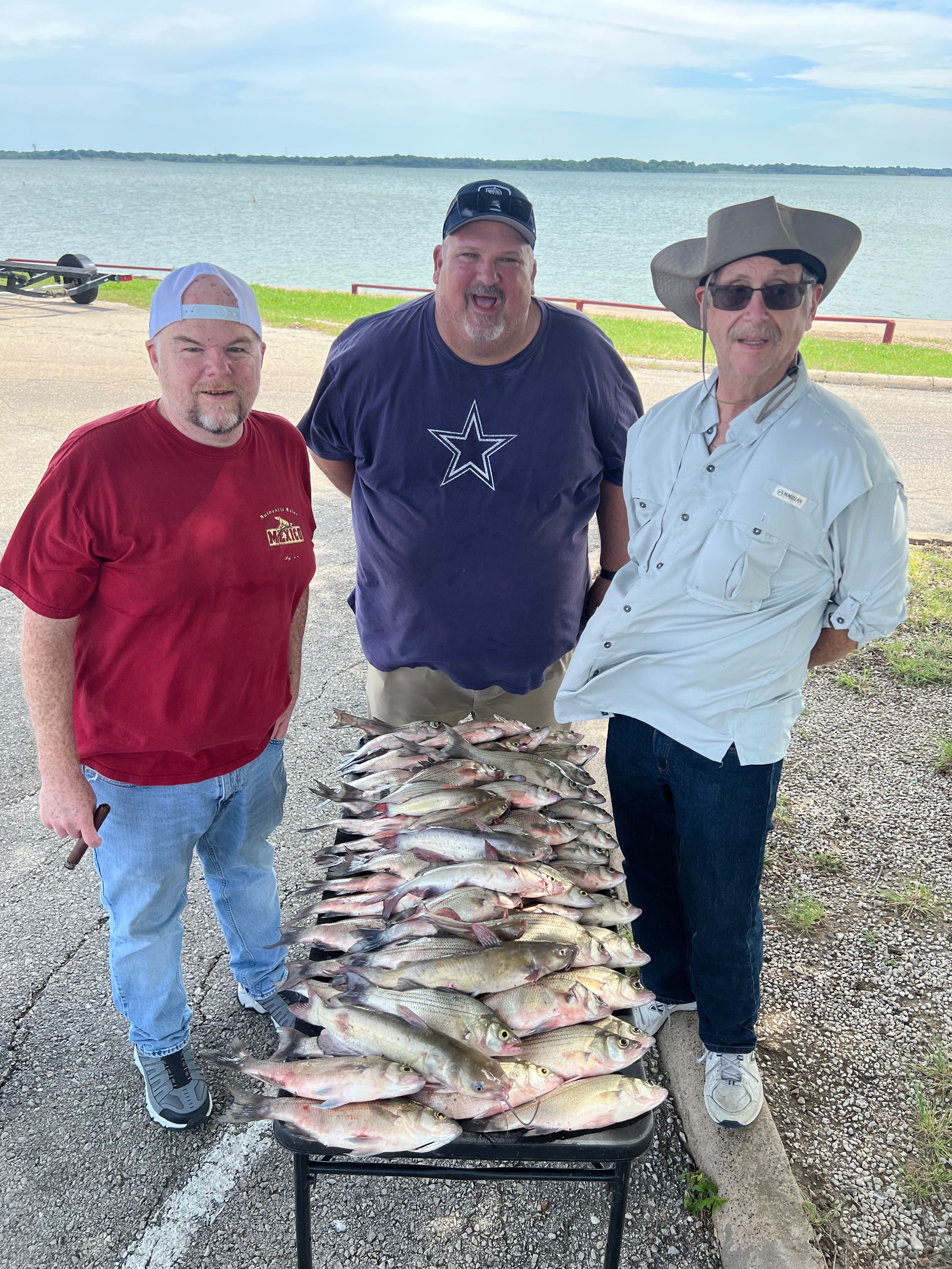 Large catch of freshwater fish displayed on table at boat launch in Wylie TX