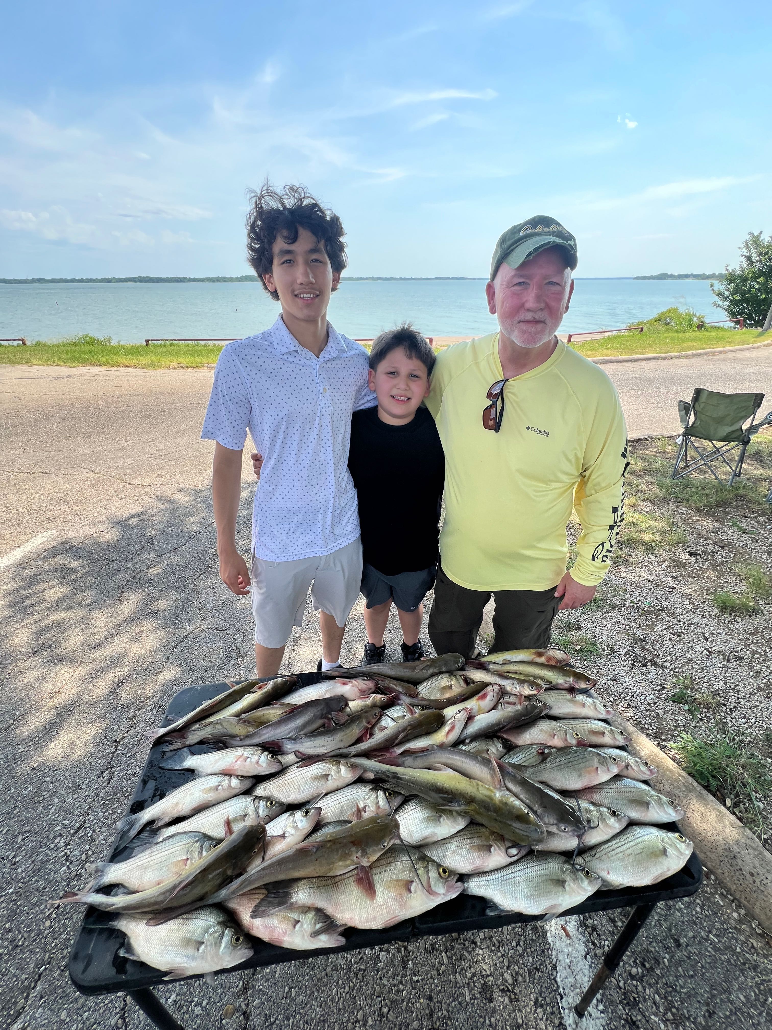 Large catch of white perch displayed on table after successful fishing trip in Wylie TX