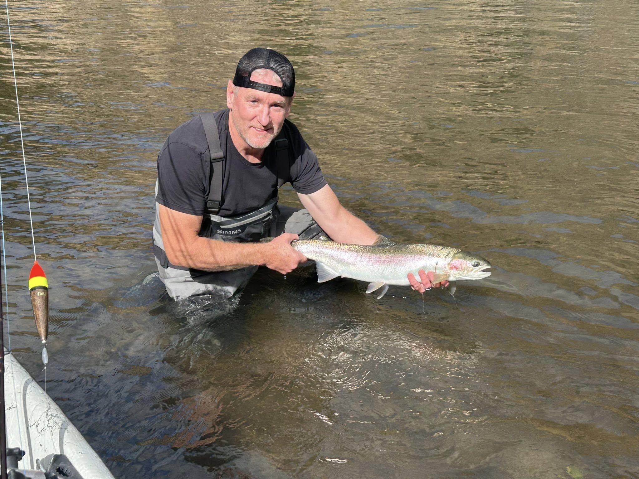 Fisherman with a rainbow trout in OR