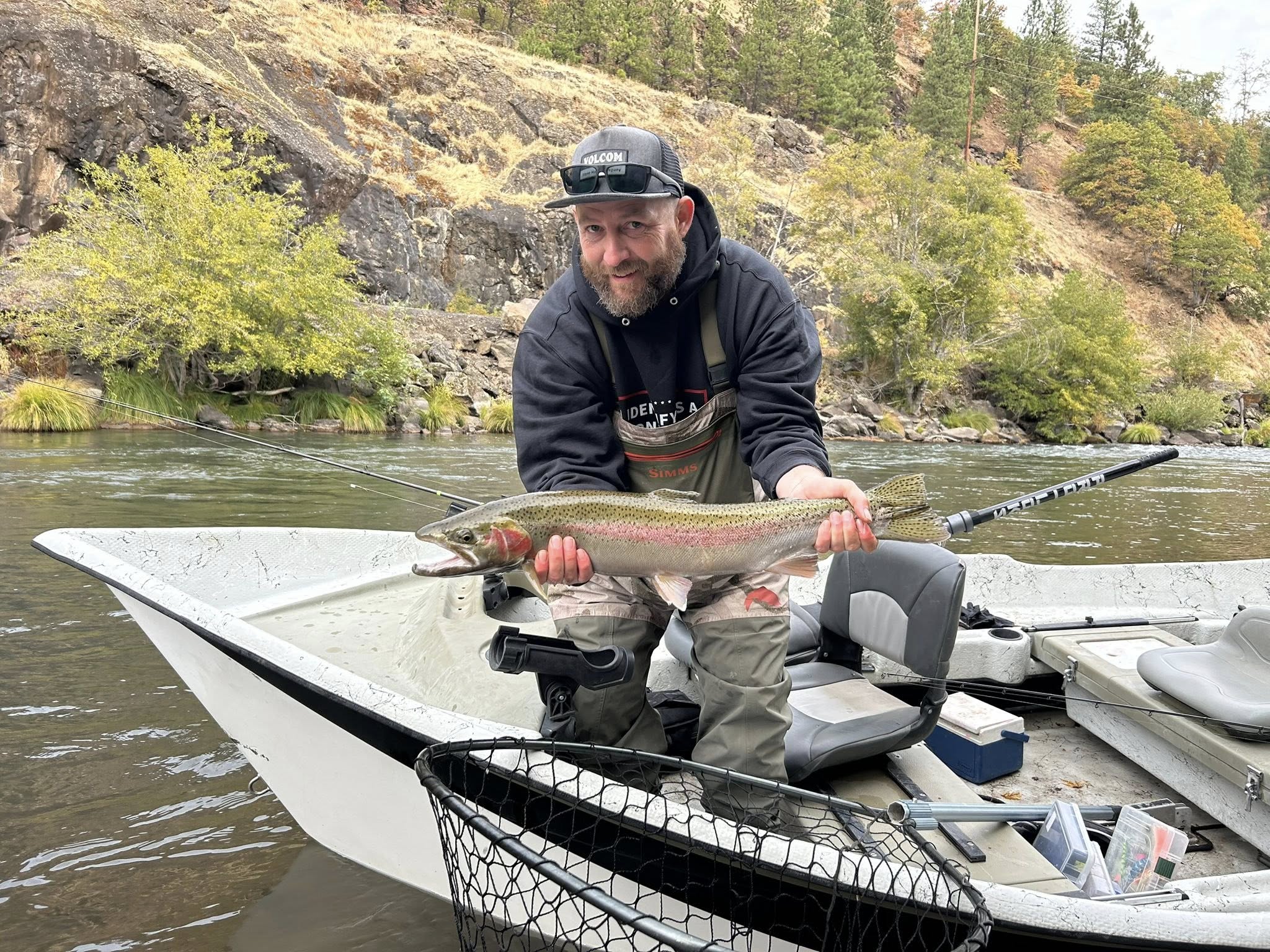 Angler landing a rainbow trout in OR