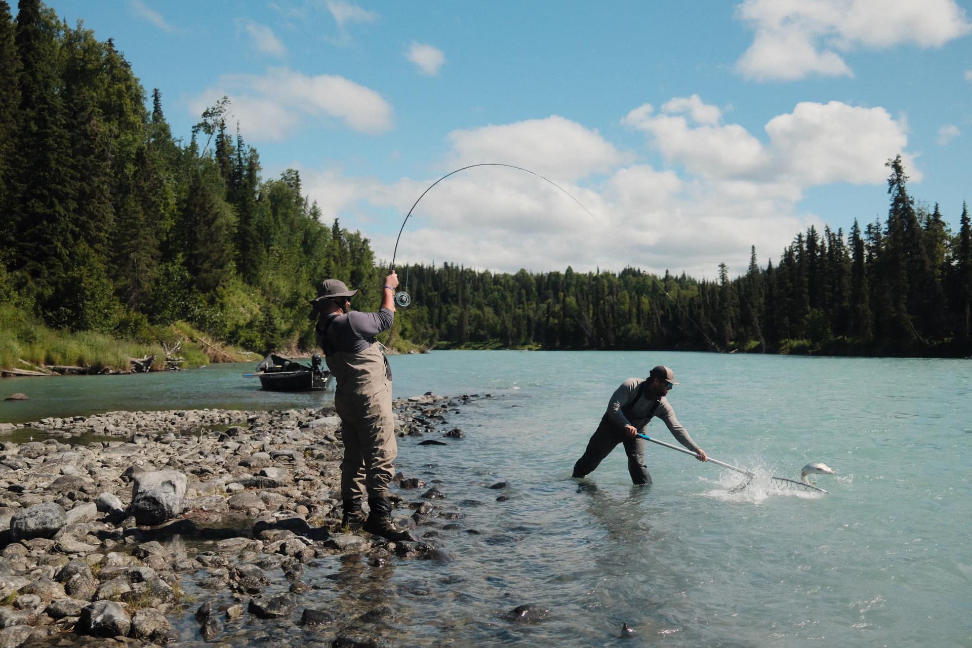 Two people fishing in AK