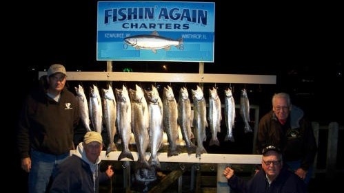 Anglers holding two big fish caught while fishing in Kewaunee