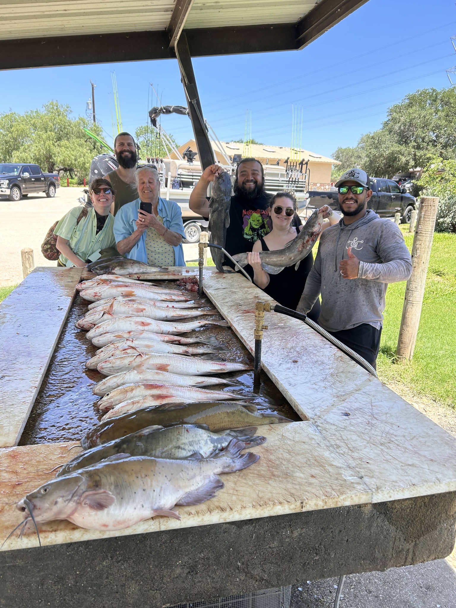 Successful catfish fishing trip in San Antonio TX showing white catfish and blue catfish catch on cleaning table