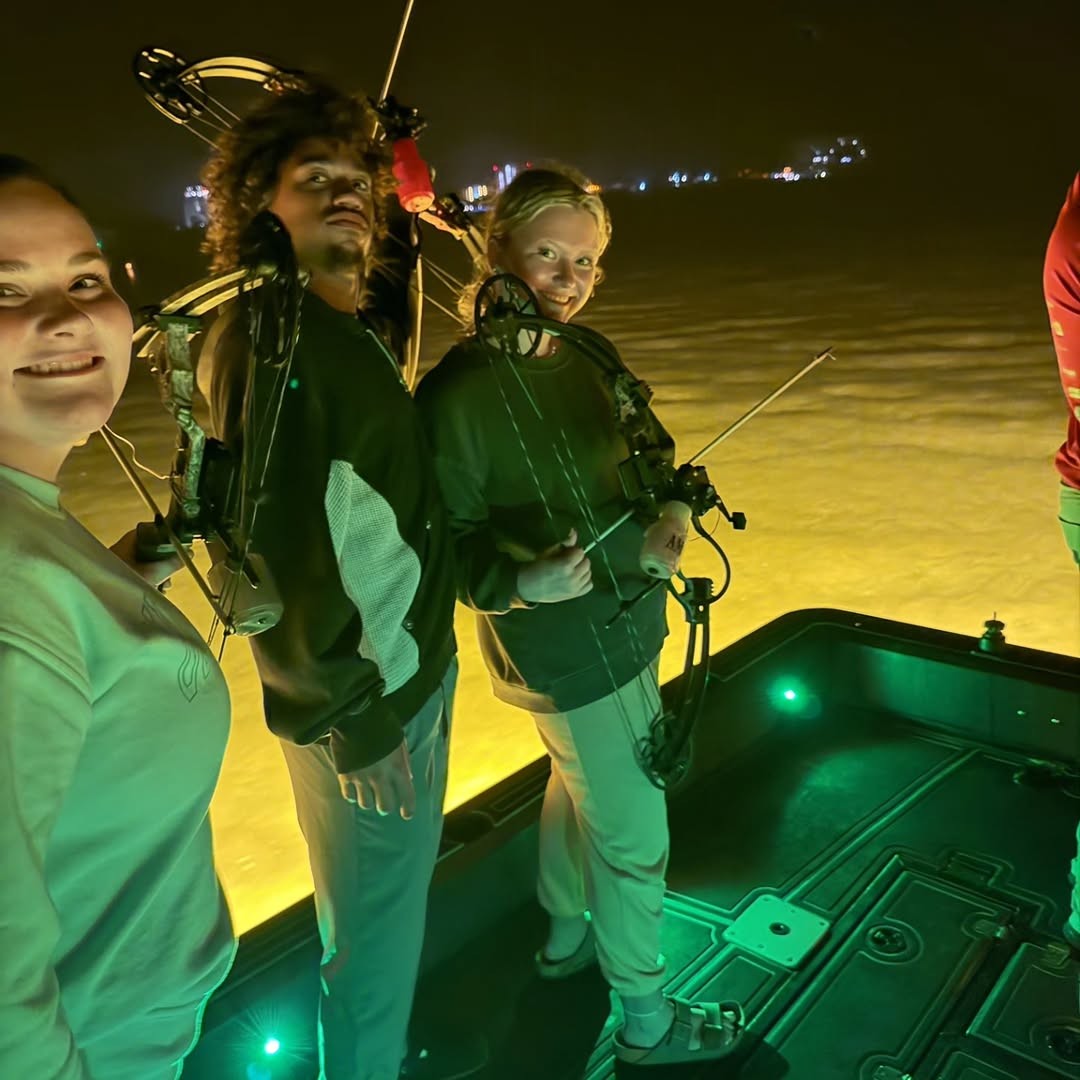 Night fishing scene on boat in Ohio with fishing equipment and green lighting
