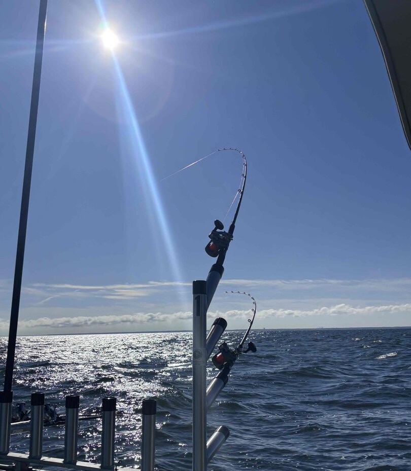 Fishing rods mounted on boat railing over open water in Lorain OH